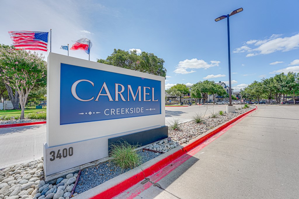 a sign for carmiel creek creekside in front of a parking lot  at Carmel Creekside, Fort Worth, Texas