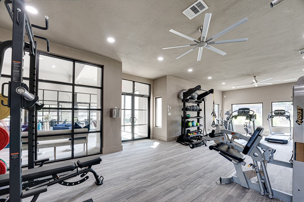 a home gym with a large window and a ceiling fan  at Carmel Creekside, Texas