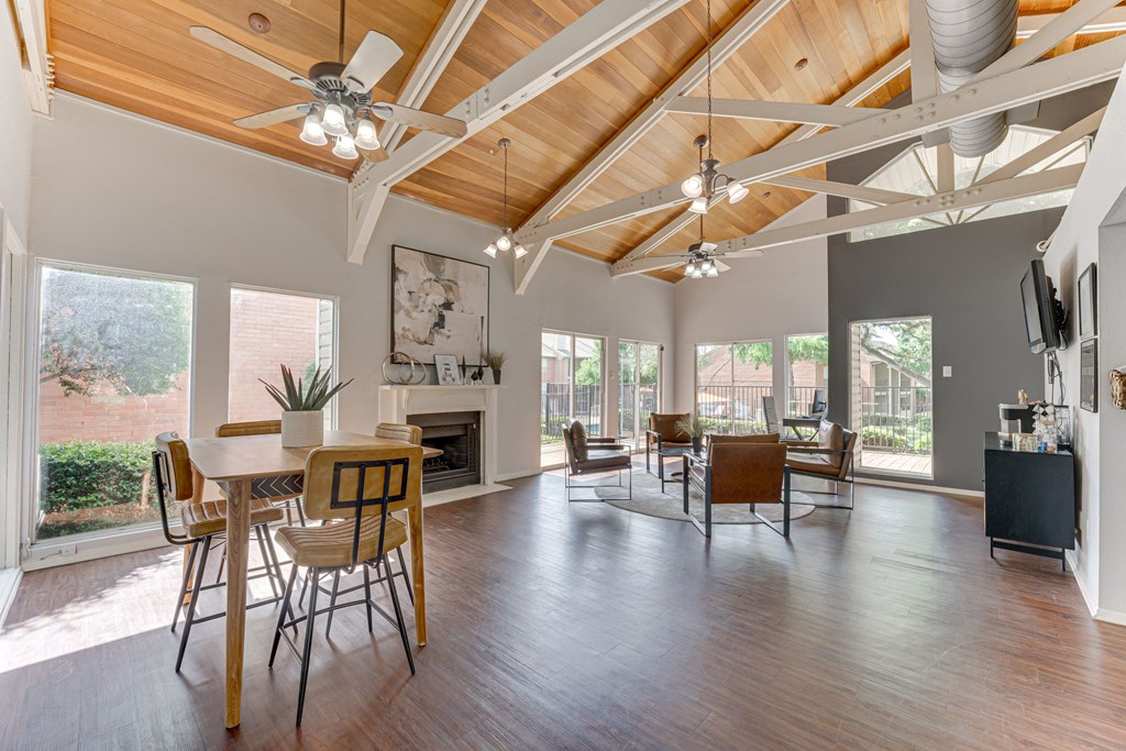 A spacious living room with wooden floors and a high ceiling at Copper Hill Apartments, Bedford 76021