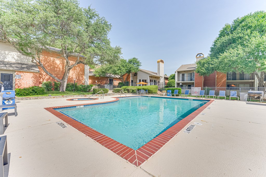 A large swimming pool surrounded by a red brick border at Copper Hill Apartments, Texas, 76021