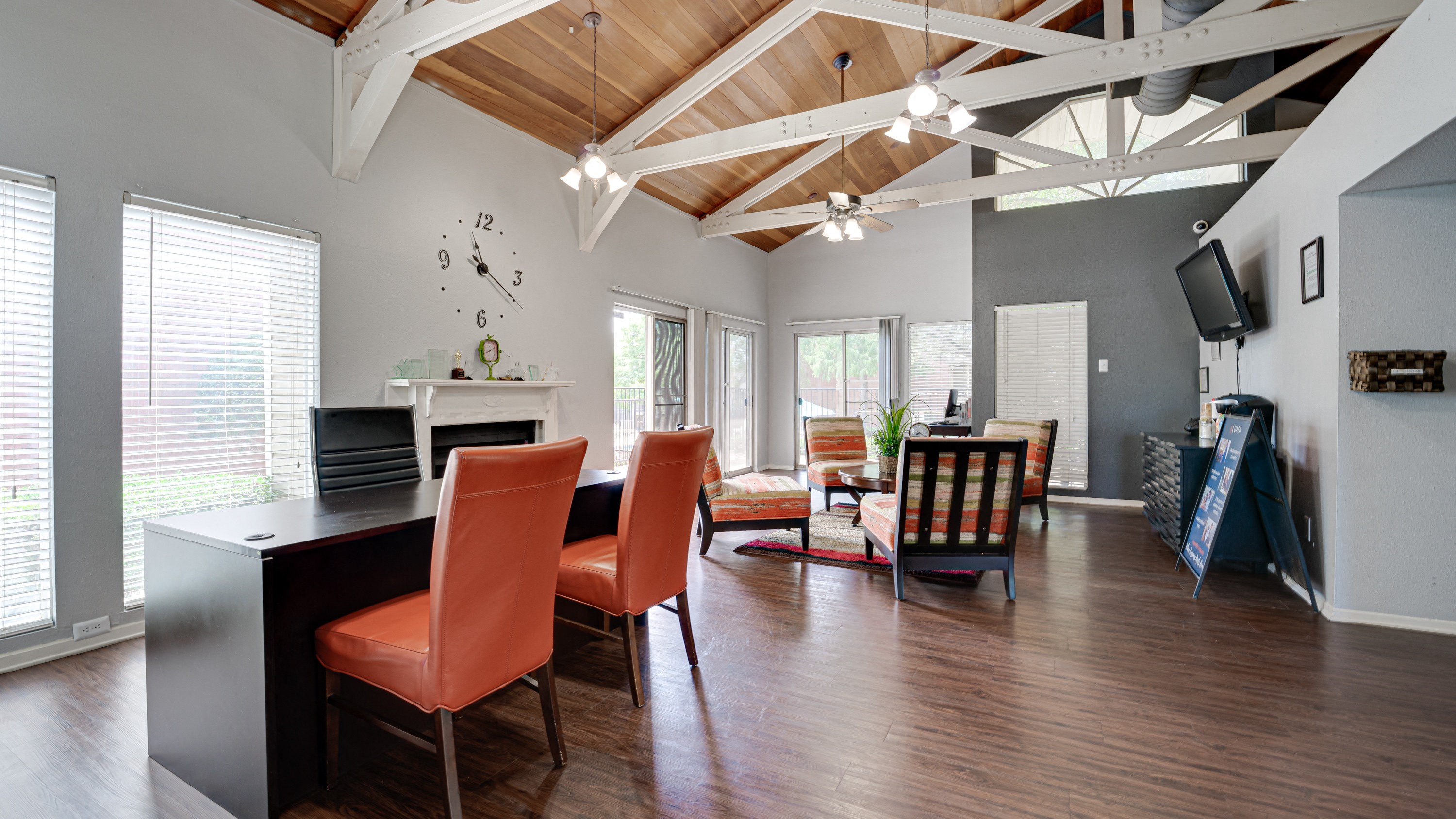 a living room with a dining room table and chairs and a piano