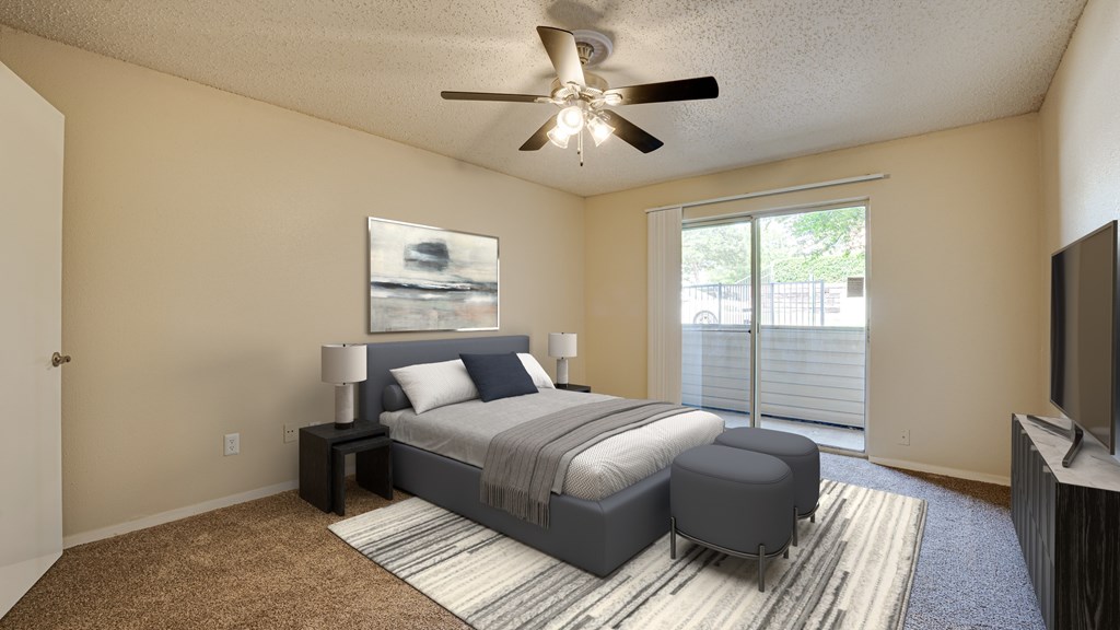 A bedroom with a bed, nightstand, and a ceiling fan at Copper Hill Apartments, Texas