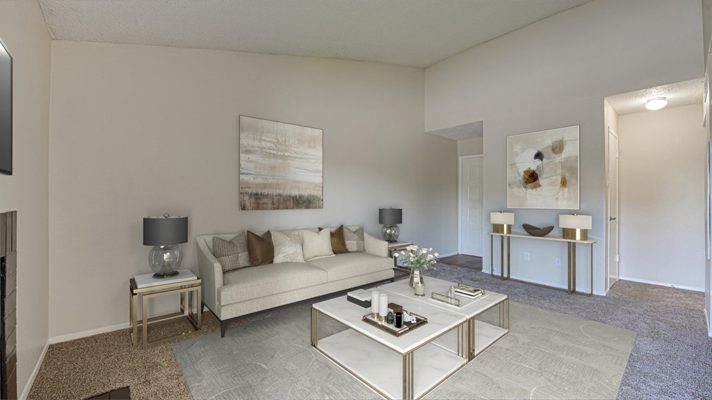 A living room with a white couch, a coffee table, and a painting on the wall at Copper Hill Apartments, Bedford, Texas