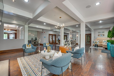 A living room with a large rug and a sofa.