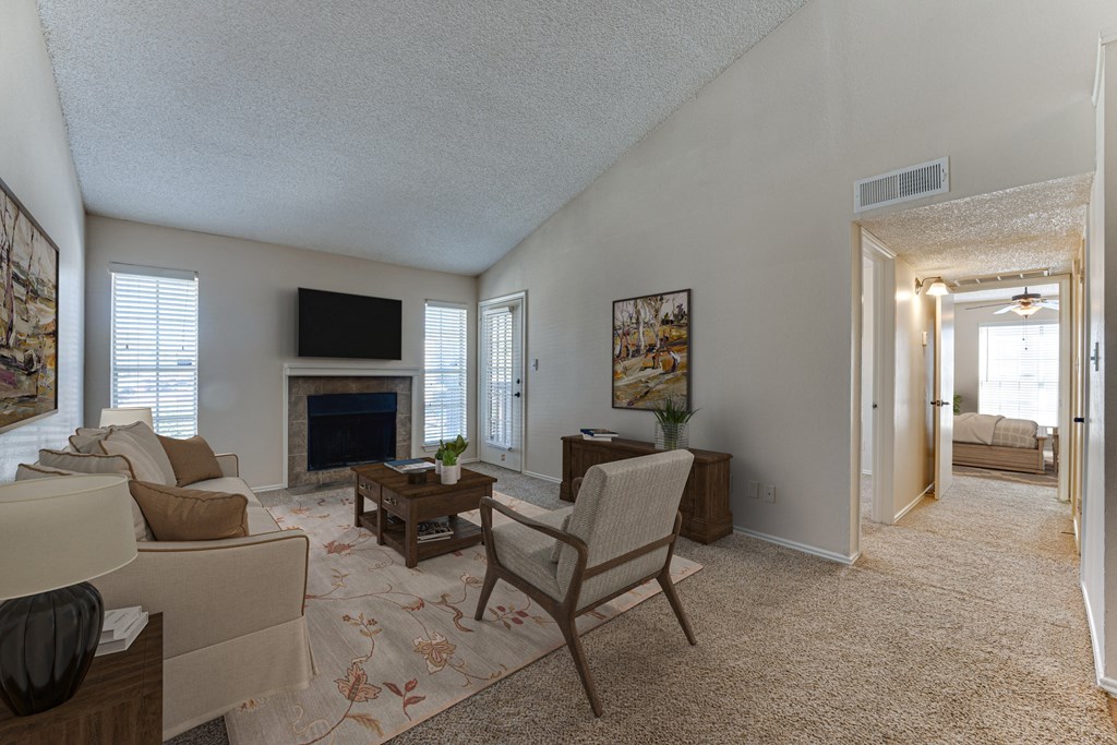 A living room with a fireplace and a television.