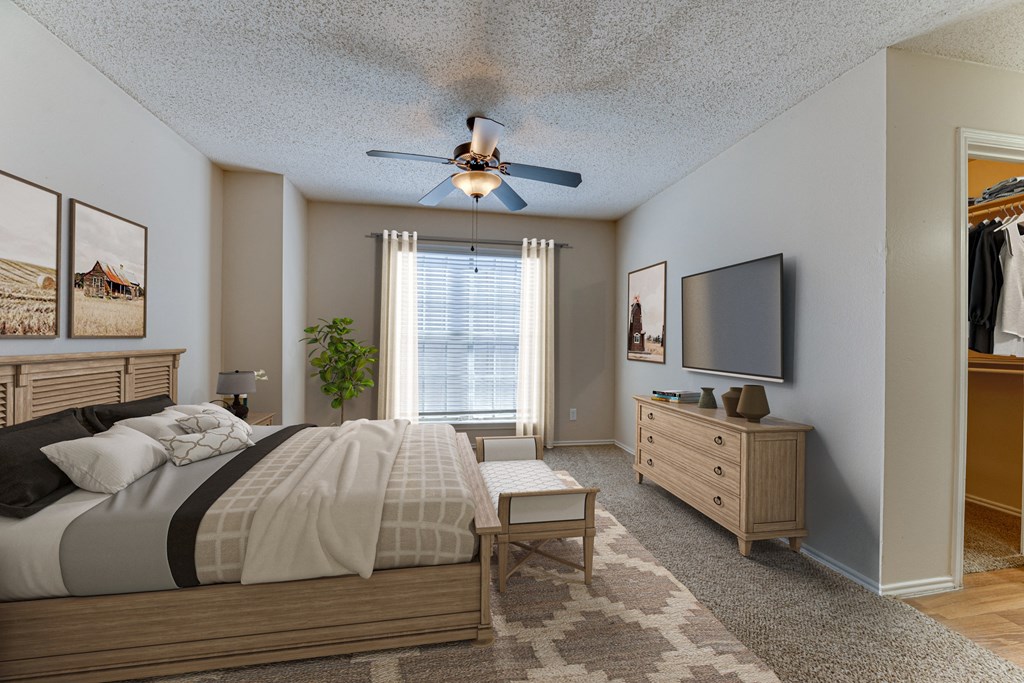 A bedroom with a bed, dresser, and window.