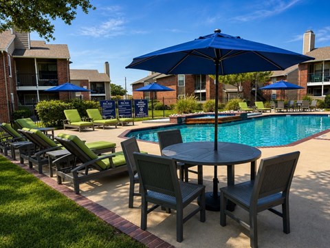 A poolside area with chairs and umbrellas.