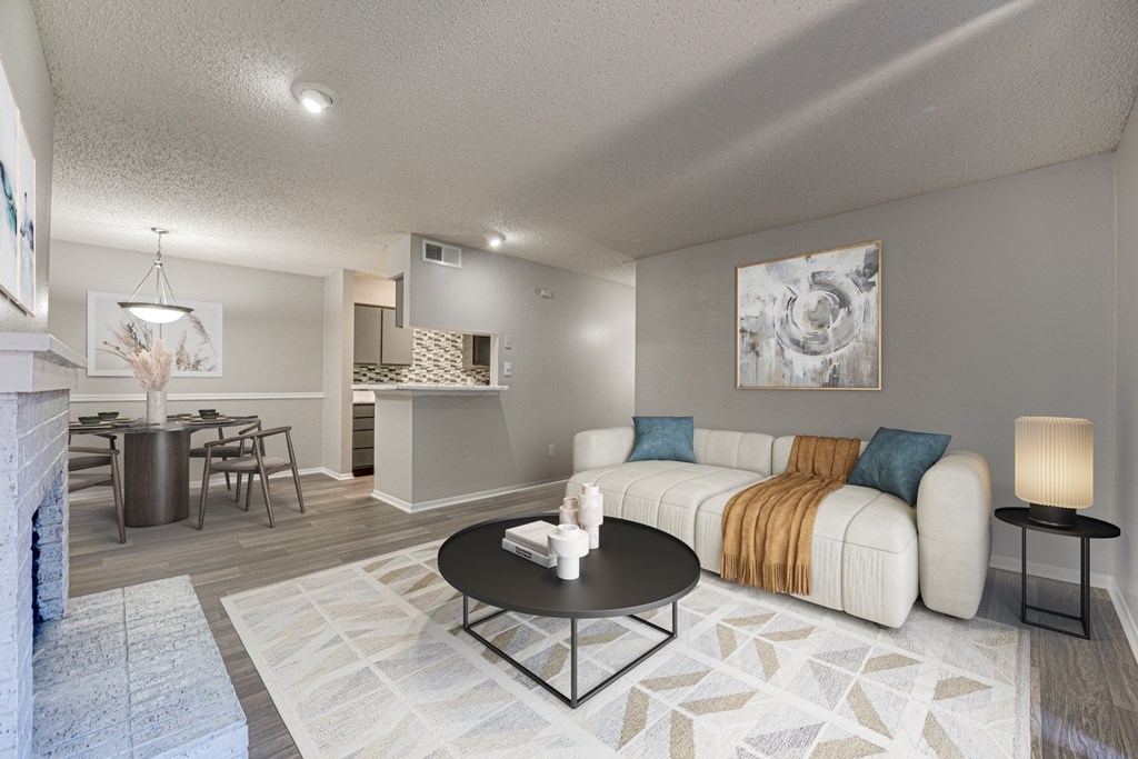 A living room with a fireplace and a couch at Indian Creek Apartments, Texas