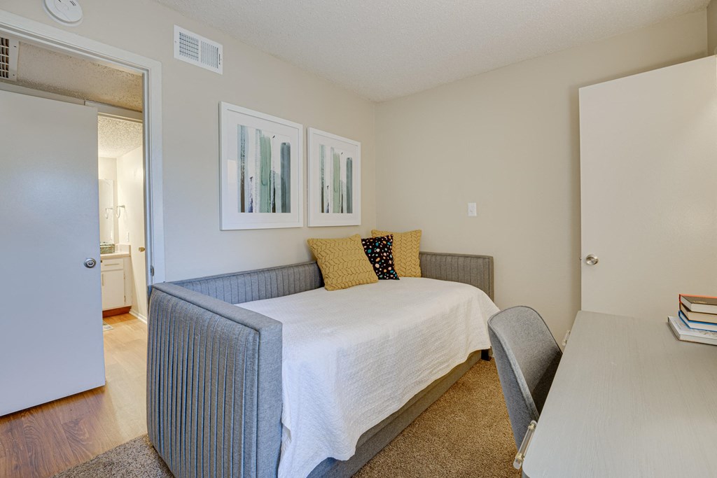 a bedroom with a bed and a desk at Indian Creek Apartments, Texas