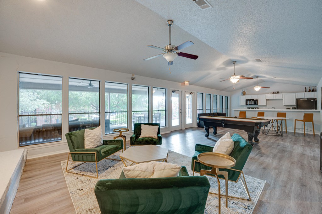 a living room with furniture and a pool table at Indian Creek Apartments, Texas