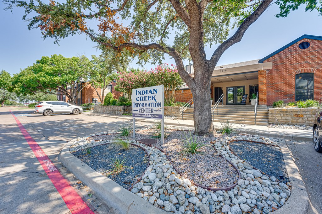 the creek neighborhood center sign in front of a tree at Indian Creek Apartments, Carrollton