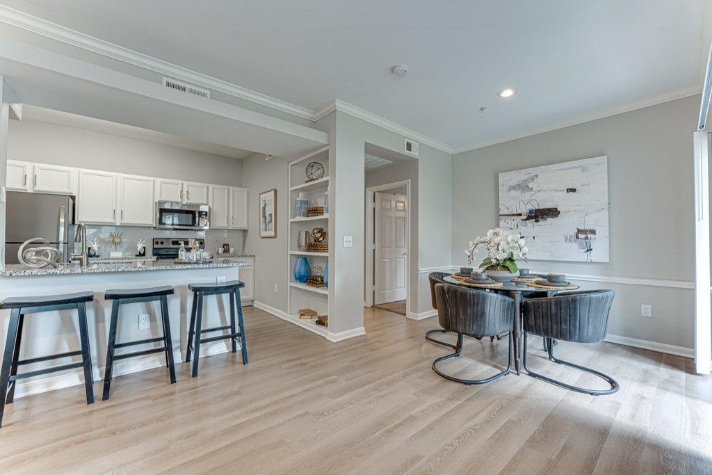 A kitchen with a bar and a dining table at Limestone Ranch Apartments, Texas, 75067