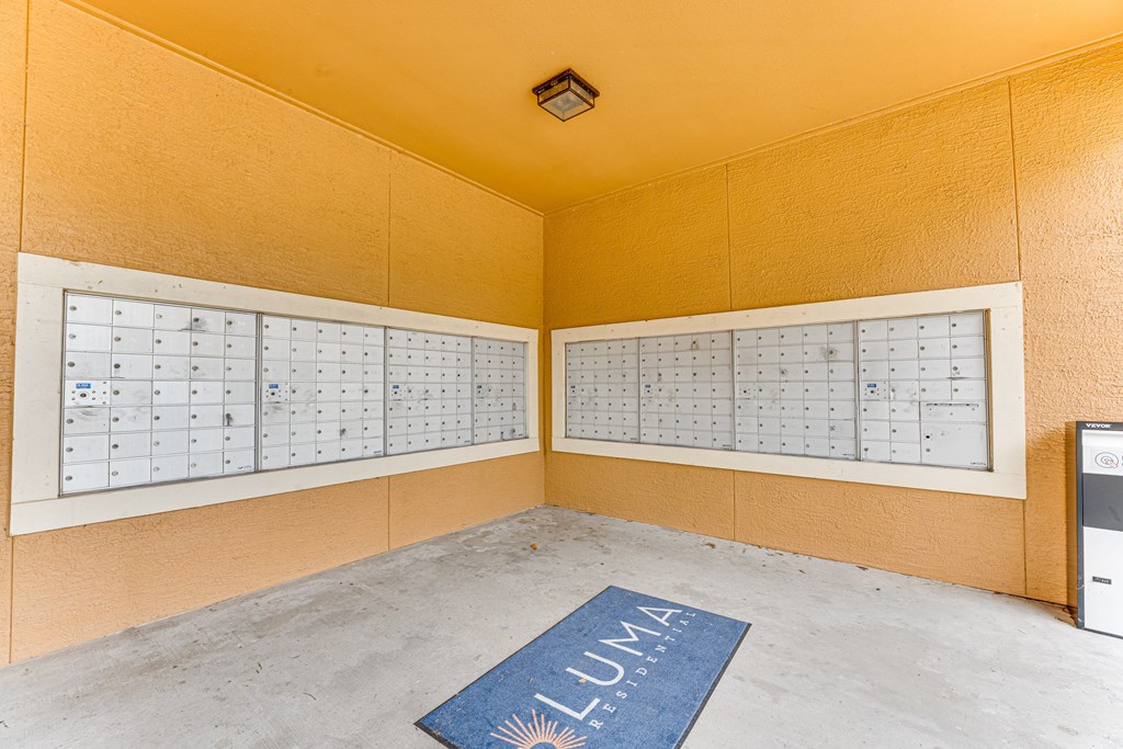 A room with a calendar on the wall and a mat on the floor with the word LUMA on it at Limestone Ranch Apartments, Lewisville, TX