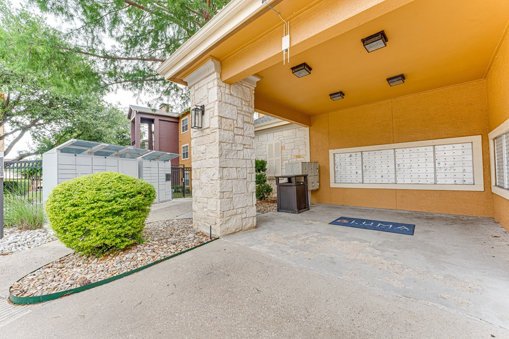 A yellow building with a parking sign in front at Limestone Ranch Apartments, Lewisville