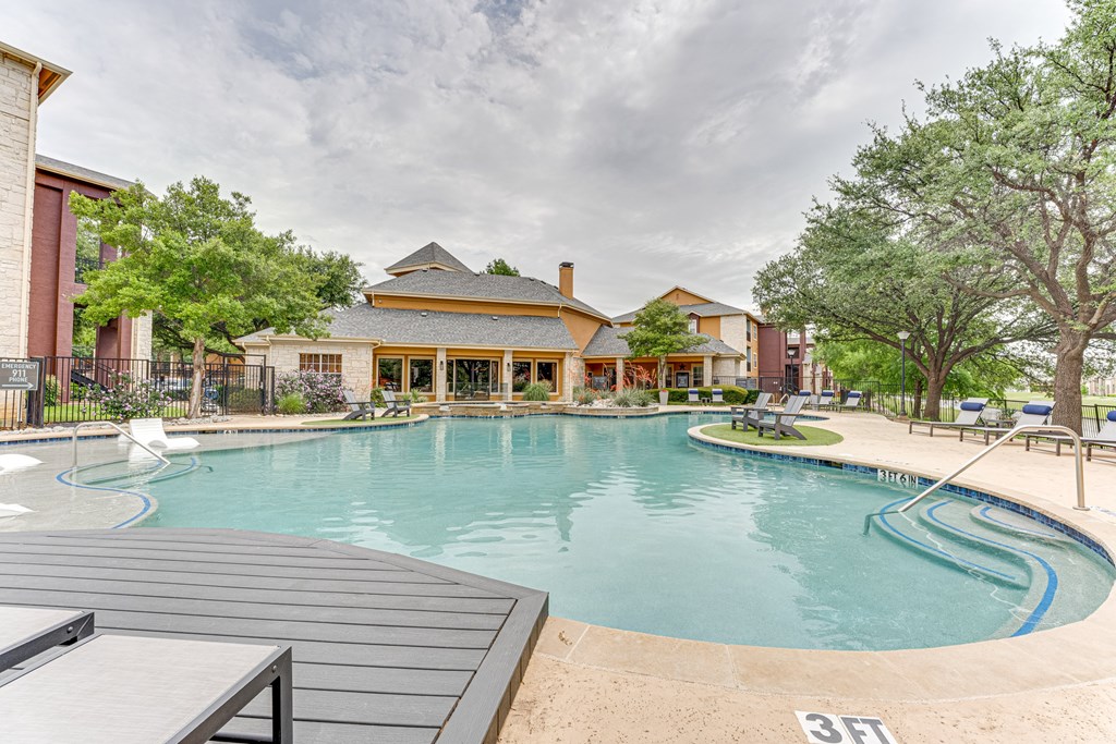 A large outdoor swimming pool with a 3 feet depth marker at Limestone Ranch Apartments, Lewisville, TX