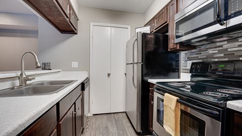 a kitchen with a sink and a refrigerator