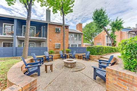 A patio with a fire pit and chairs. at The Manhattan Apartments, Dallas, TX