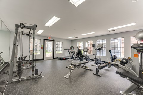 A spacious gym with various exercise equipment. at The Manhattan Apartments, Dallas, TX