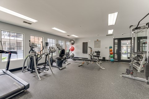 A gym with treadmills, weights, and exercise equipment. at The Manhattan Apartments, Dallas, Texas