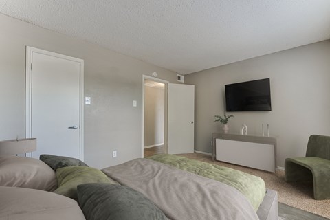 Bedroom With TV at The Manhattan Apartments, Dallas, Texas