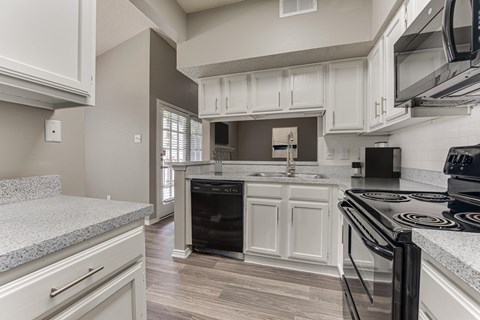 A kitchen with a black stove top oven.