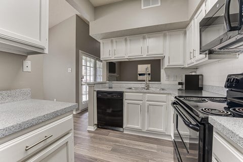 A kitchen with a black stove top oven.