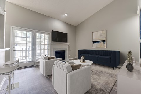 A living room with a fireplace at The Manhattan Apartments, Dallas, TX, 75252