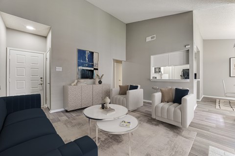 A living room with a dark blue sofa and a white coffee table.