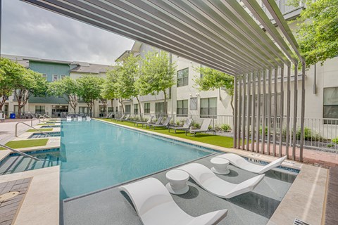 Pool area with tanning ledge and modern pergola at The Montrose Apartments, Dallas, 75204