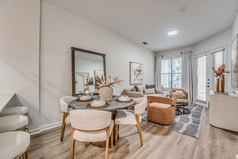 Open concept dining and living room with modern furnishings at The Montrose Apartments, Texas