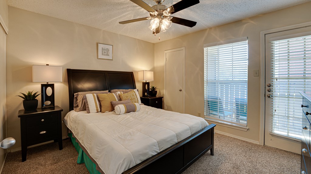 a bedroom with a large bed and a ceiling fan at Paces Crossing, Texas
