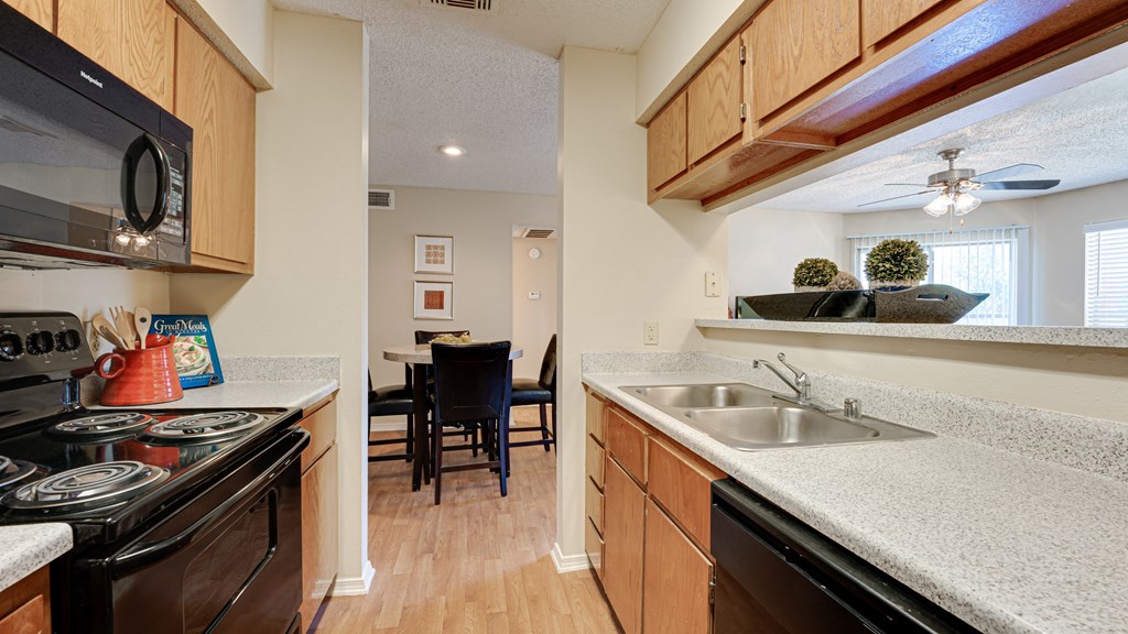 the view of a kitchen with a sink and a stove and a dining room area at Paces Crossing, Denton, Texas