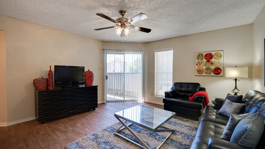 a living room with leather furniture and a glass coffee table at Paces Crossing, Denton, 76210