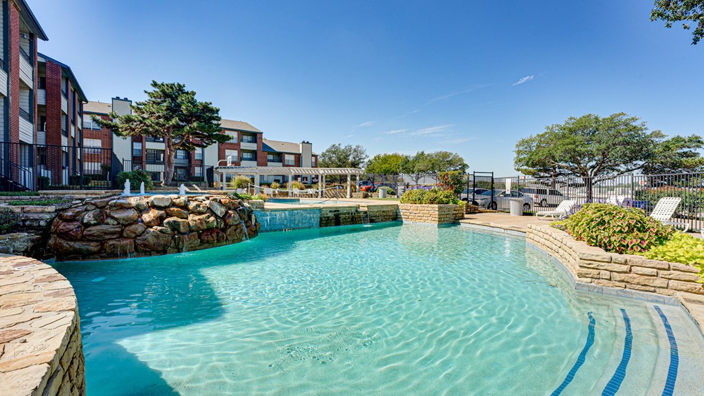 a large pool with a building in the background  at Paces Crossing, Denton