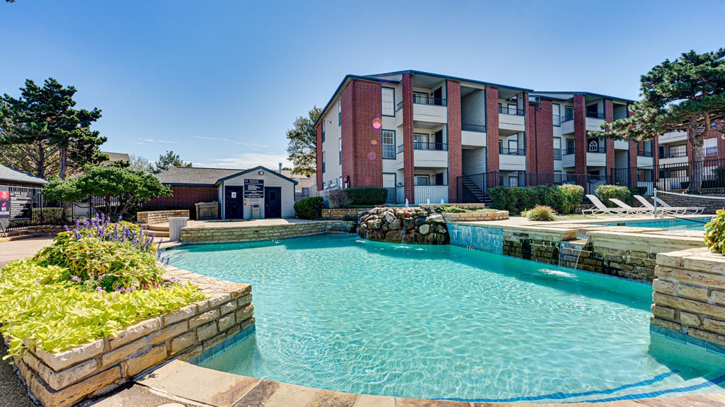 a swimming pool with an apartment building in the background  at Paces Crossing, Denton, 76210