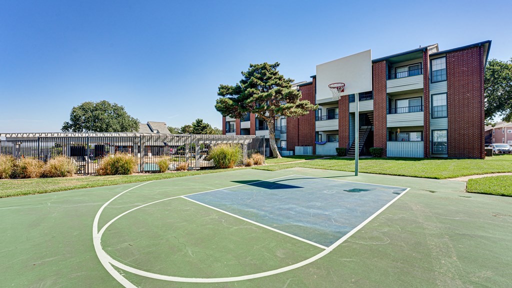 a basketball court in front of an apartment building at Paces Crossing, Denton, TX