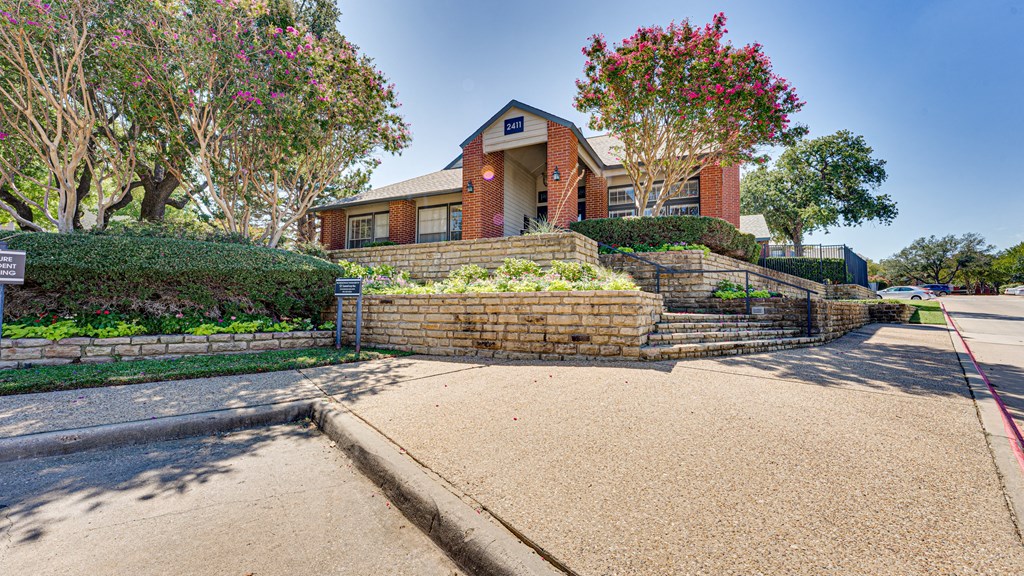 a brick retaining wall in front of a house at Paces Crossing, Texas