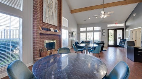 a dining room with a table and chairs and a fireplace at Paces Crossing, Denton, Texas