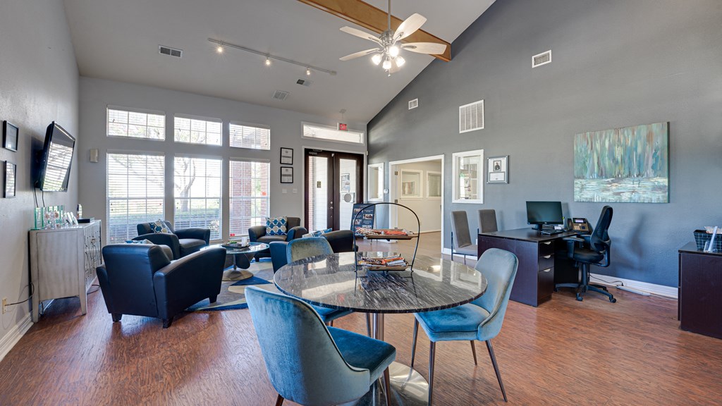a living room with a round table and chairs and a desk with a computer at Paces Crossing, Denton, TX