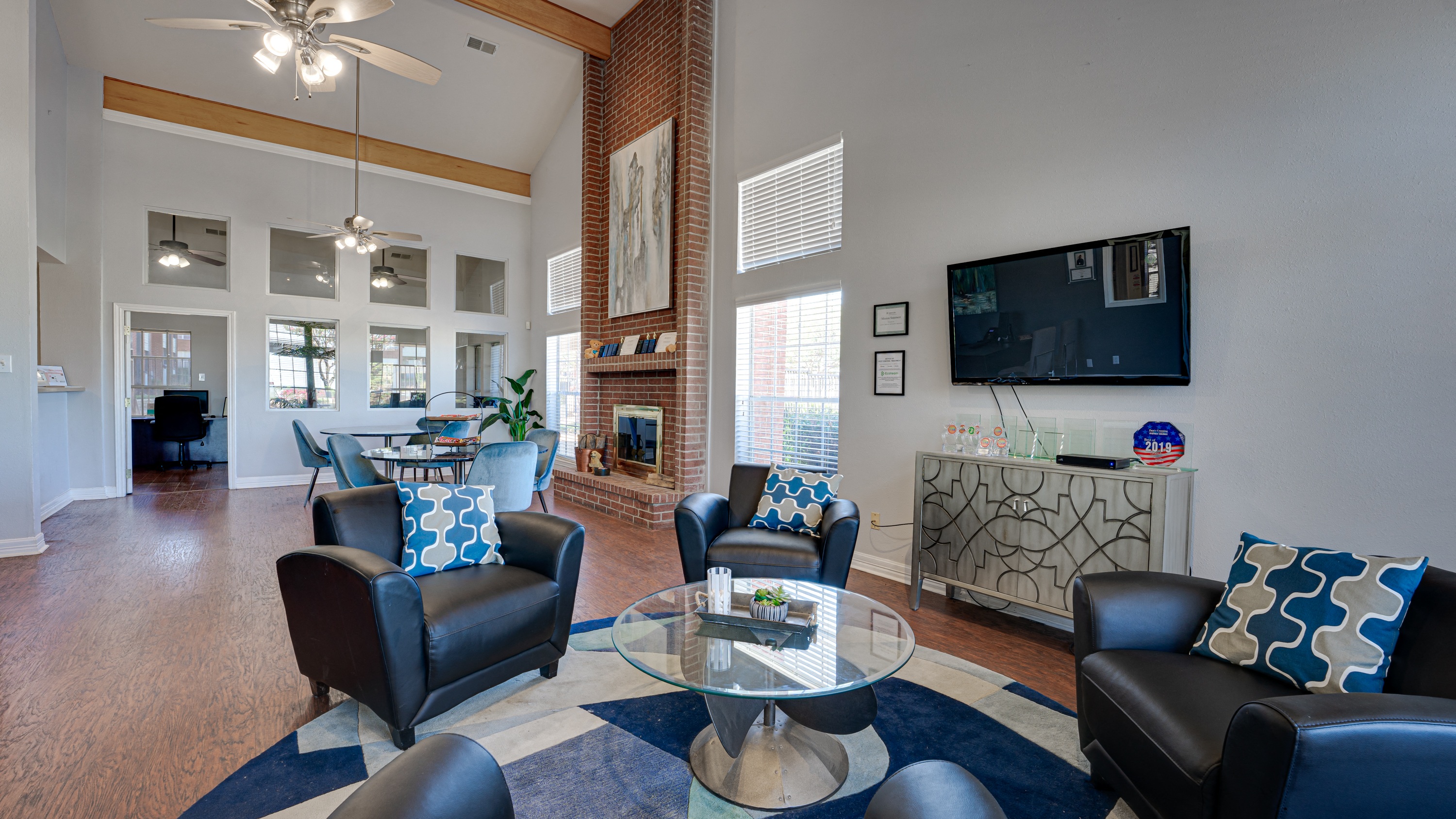 a living room with couches and a table and a television