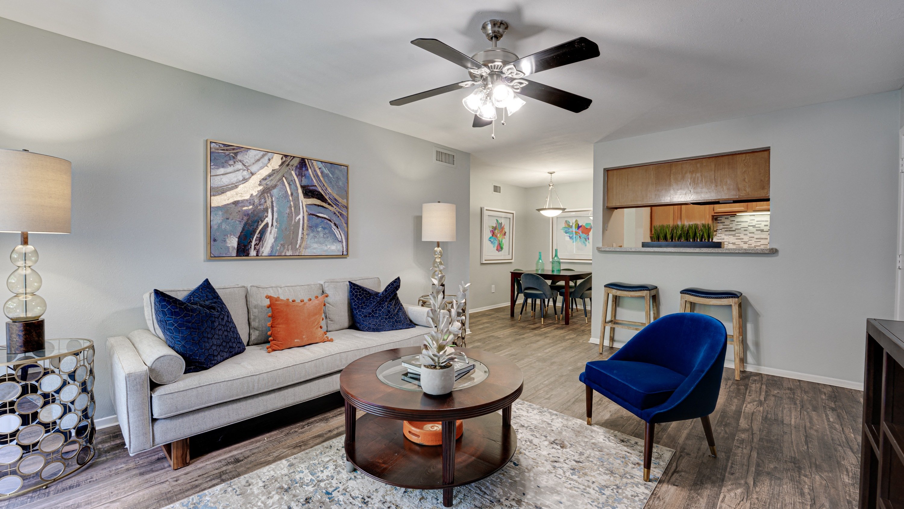 a living room with a ceiling fan and a couch