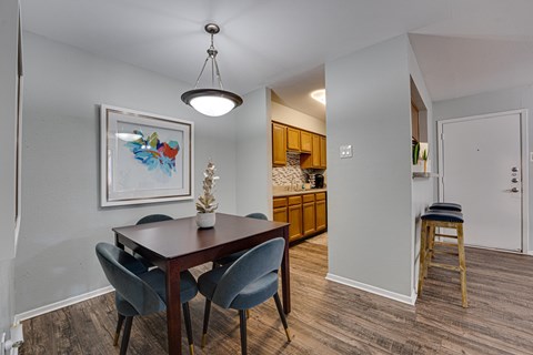 A dining room with a wooden table and chairs.