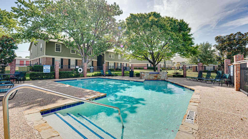 main pool with lounge chairs main pool with lounge chairs at Arbors Of Cleburne, Cleburne, TX