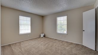 spacious living room with carpet  at Arbors Of Cleburne, Cleburne, TX - Photo Gallery 2