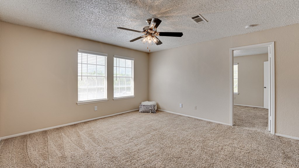 spacious bedroom with carpet & ceiling fan  at Arbors Of Cleburne, Cleburne, 76033