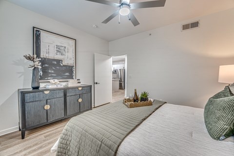 Bedroom with ceiling fan and hardwood flooring at The Barton Apartments, Texas, 75206