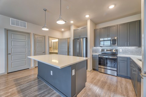 A modern kitchen with a large island in the middle.