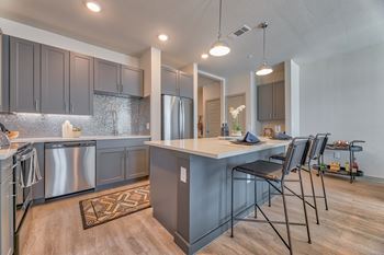 A kitchen with a large island and modern appliances.
