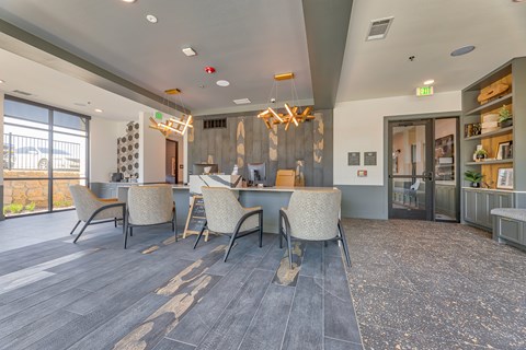 A room with a long table and chairs with a view of the outside.