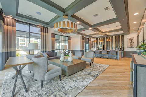 A modern living room with a grey sofa and a wooden coffee table.